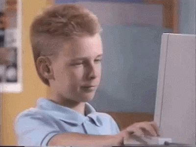 Animated GIF of a boy at a computer giving an approving thumbs up