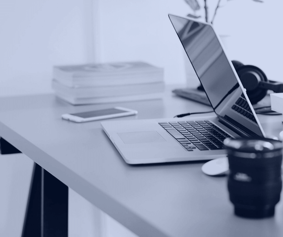 A laptop and a few books on a tidy desk